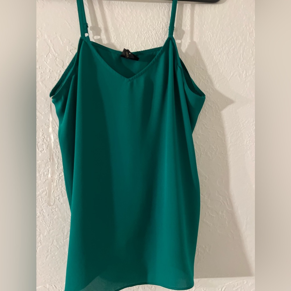 S size top is a really dark bright green